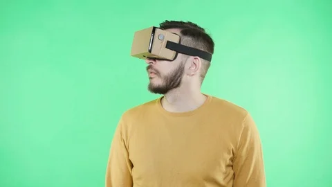 Man in vr headset on the green background Stock Footage 87379949
