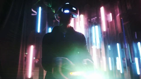 Man in VR headset holding joystick in backlit Stock Footage 103630890