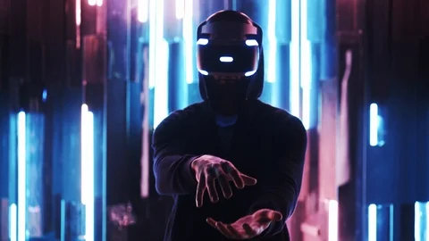 Man in VR headset making gesture in neon light Stock Footage 103627664