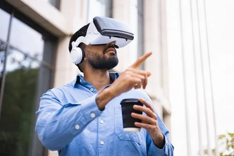 Man in VR Headset Pointing Up Stock Photos