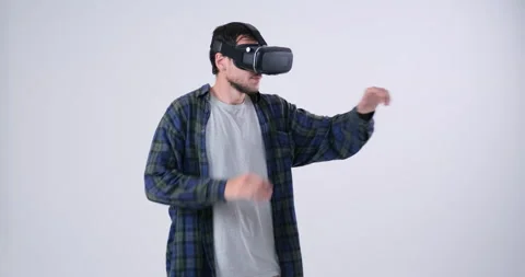 Man in VR headset pressing button on virtual screen Stock Footage 143945275