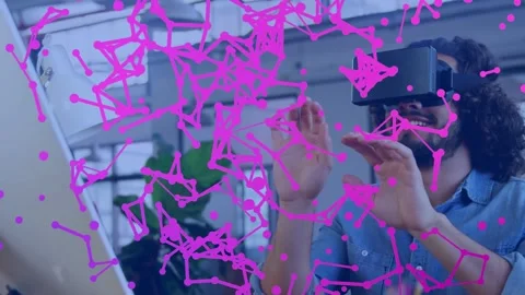 Man with VR headset raising hands and activating particle net in tech hub, 動画素材 331593677