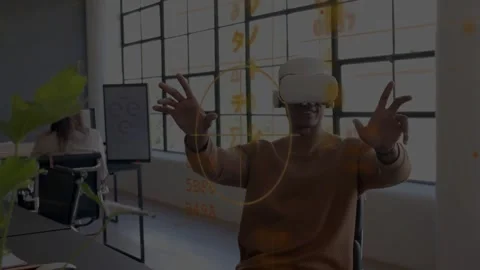 Man with VR headset raising hands in tech office starting orange HUD forming Stock Footage 334035020
