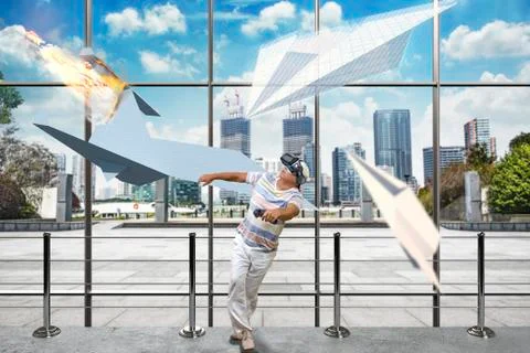 Man in VR headset surrounded by paper airplanes Foto stock