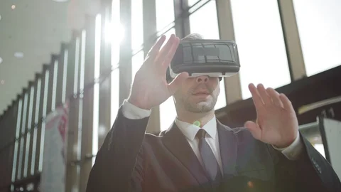 Man in VR headset swiping analytical data Video stock 108682779