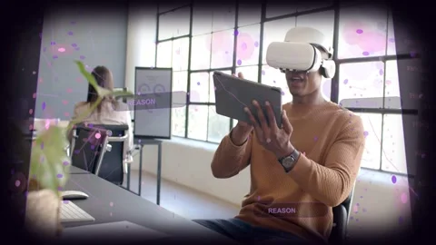 Man with VR headset tapping tablet in office causing REASON PATTERN labels and Stockbeeldmateriaal 333004686
