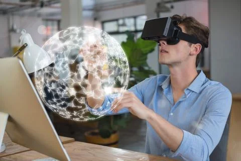 Man in VR headset touching a 3D sphere interface Fotos Stock