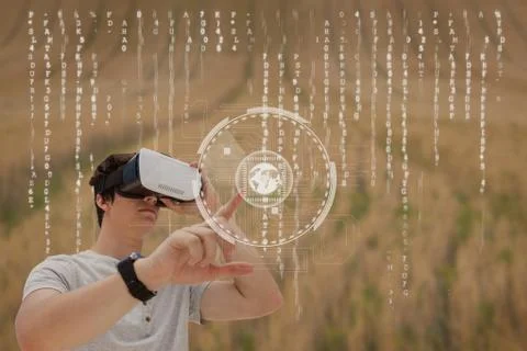 Man in VR headset touching interface against field background with interface Stock Photos