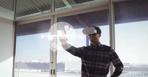 Man in VR headset touching interface Stock Photos