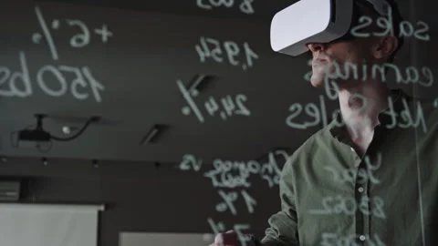 Man in VR Headset Using Remote Controller and Testing New App in Office Stock Footage 275074545