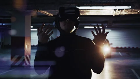 Man in VR Headset Walking Slowly Through Digital World in Parking Lot Vidéo 332538654
