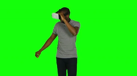 Man in the VR mask something crosses legs in the air. Green screen Stock Footage 65217346