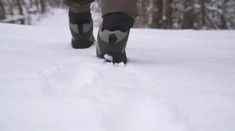 Man in waders walking through snow Stock Footage 65071834