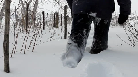 Man wades knee-deep through snow - countryside Stock Footage 1098476