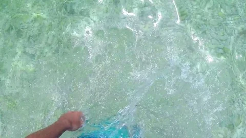 Man wades into the sea while on a beach vacation and dips to have a swim Video stock 74200207