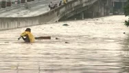 Man Wades Through Dangerous Flood Waters In Manila Philippines Stock Footage