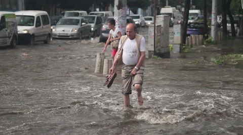 Man wading in the waters of heavy flood Stock Footage 62551364