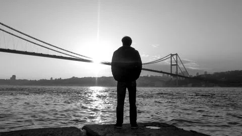 Man waiting by the Bosphorus, dramatic black and white Istanbul scene text .. Stock Photos
