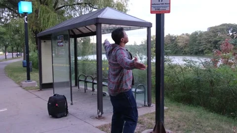 Man waiting at bus stop Video stock 171342260