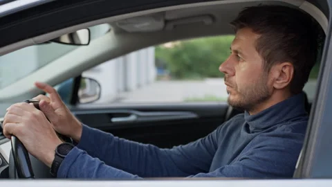 Man waiting in car and checking the time Stock Footage 340490145