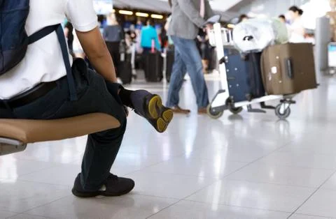 A Man Waiting for His Flight on the Background of Passersby with Luggage at t Stock Photos