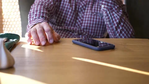 A man is waiting for his order in a restaurant, drumming his fingers. Stock Footage 209168637