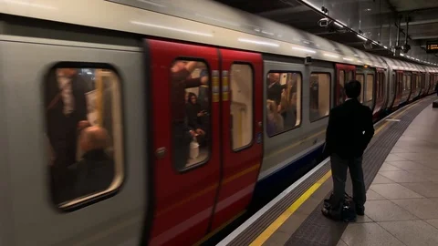 Man waiting on platform at Westminster underground train station in London Stock Footage 98540333