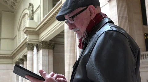 Man waiting for train inside station with tablet Stock Footage 48706788