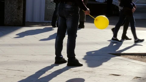 Man waiting with yellow balloon Stock Footage 86137540