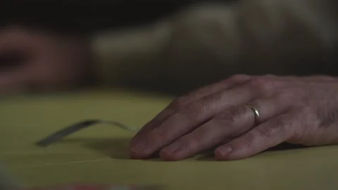 Man waits for dinner to be served to him, picks up fork. Close to hand on table Stock Footage 166365395