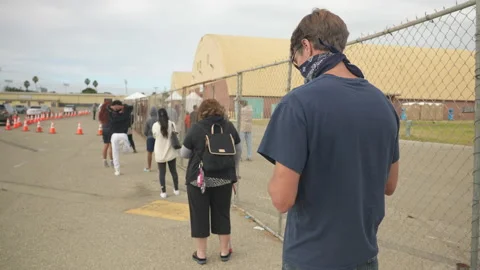 Man waits in line to get tested for covid-19 Stock Footage 143431470