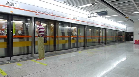 Man waits for the train while the train is moving into the subway station Stock Footage 42622876