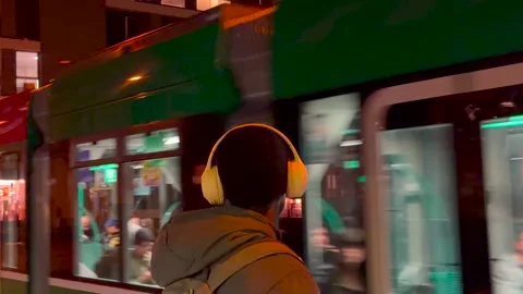 A man waits for the tram to stop so he can get on. Stock Footage 322224074