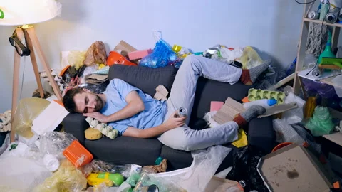Man wake up on the sofa in the room with garbage. Holding bottle of beer. Stock Footage 120423887