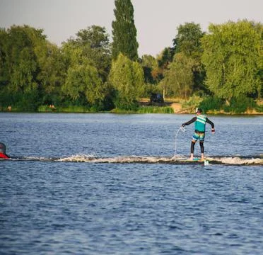 Man on a wakeboard in the river at daytime Stock Photos