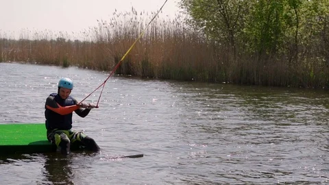 A man on a wakeboard starts Stock Footage 107537583