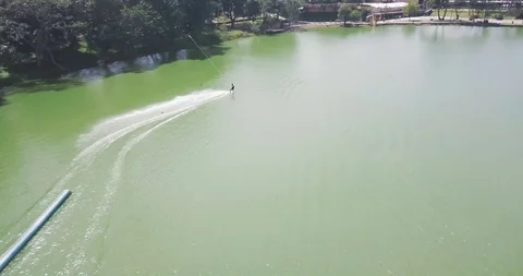 Man Wakeboarding Cable. Smooth Slide on Water Aerial View Vídeo Stock 88976696
