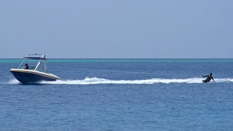 A Man Wakeing Behind The Powerboat Stock Footage 125977605