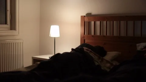 Man wakes up in the middle of the night, unable to sleep, suffering from inso Stock Footage 117889592