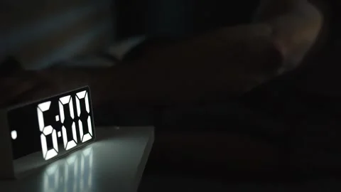 Man waking up at 6 a.m with digital alarm clock Stock Footage 294311785