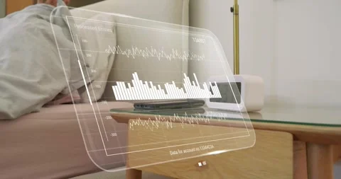 Man waking to alarm and reaching bedside, checking AR biometric sleep charts Stock Footage 323354980
