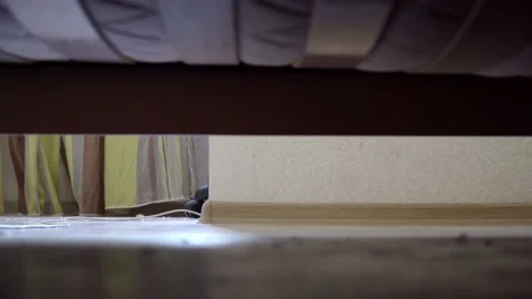 Man waking up and get out of bed. View from under the bed. Stock-Footage 109116730