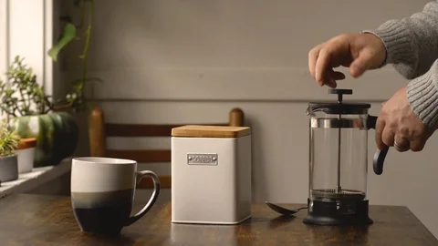 Man Waking Up And Putting Coffee Grinds In A French Press Stock Footage 117692681