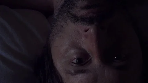 Man waking up from bad dream or nightmare Stock Footage 77603722