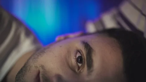 Man waking up in bed, insomnia, poor sleep Stock Footage 71898774