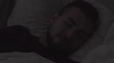 Man waking up in bedroom Stock Footage 63364111