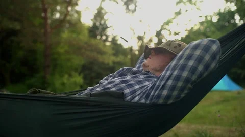 A man waking up with a hat on his face Stock Footage 151136864