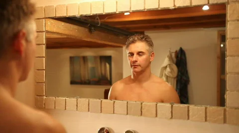 Man waking up looking in mirror Stock Footage 606113