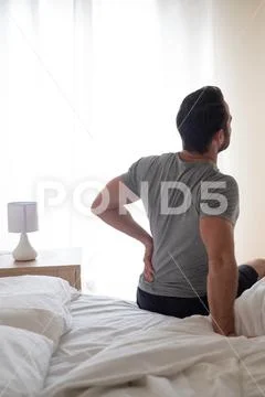 Man waking up in the morning and suffer for back pain Stock Photos