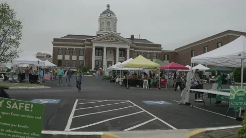Man Walikng Toward Camera, Leaving Local Farmer's Market. 4K Stock Footage 152647566